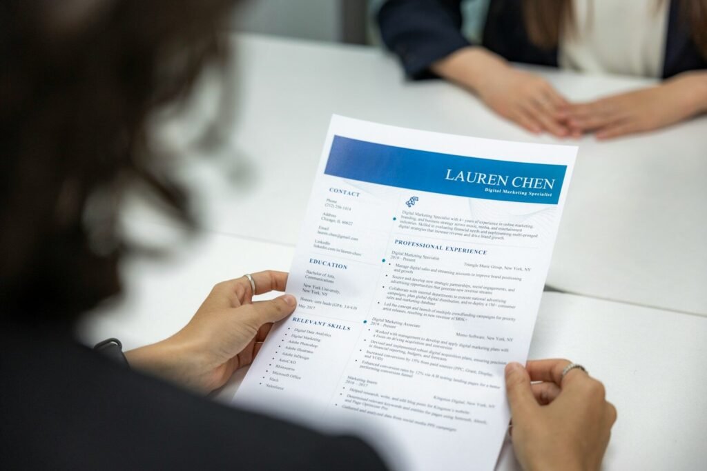 Woman reading a resume at a table, illustrating AI help for job seekers