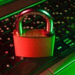 Red padlock on a black computer keyboard, illustrating cybersecurity threats in 2026